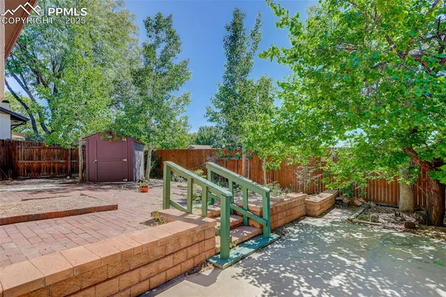 a view of a wooden deck and a backyard