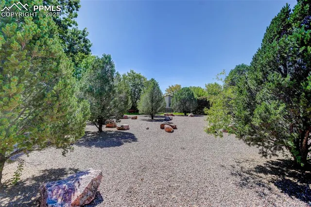 a view of a backyard with sitting area