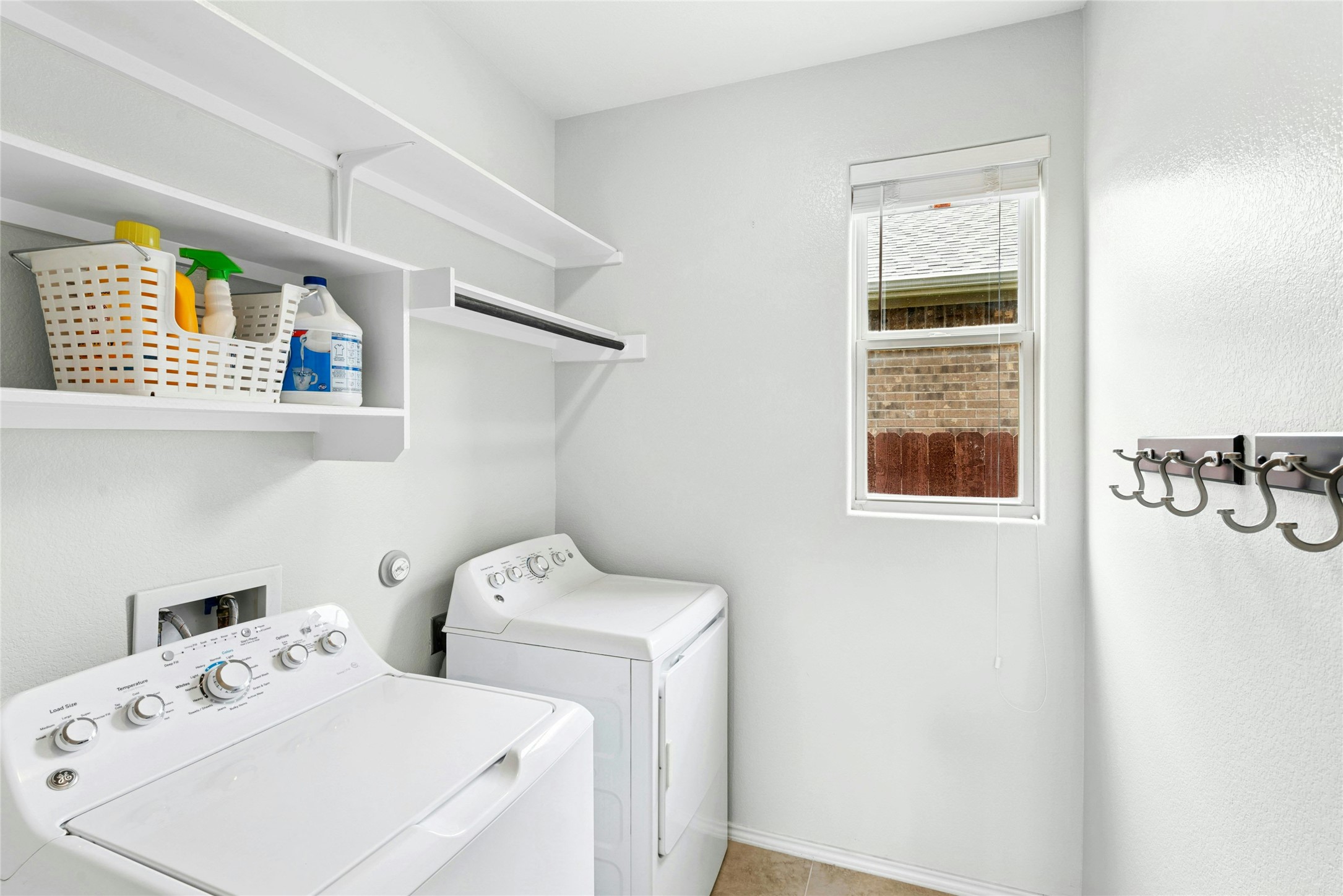 390 Fletcher Bend Buda, TX 78610 - Photo 24 of 36 a utility room with dryer and washer