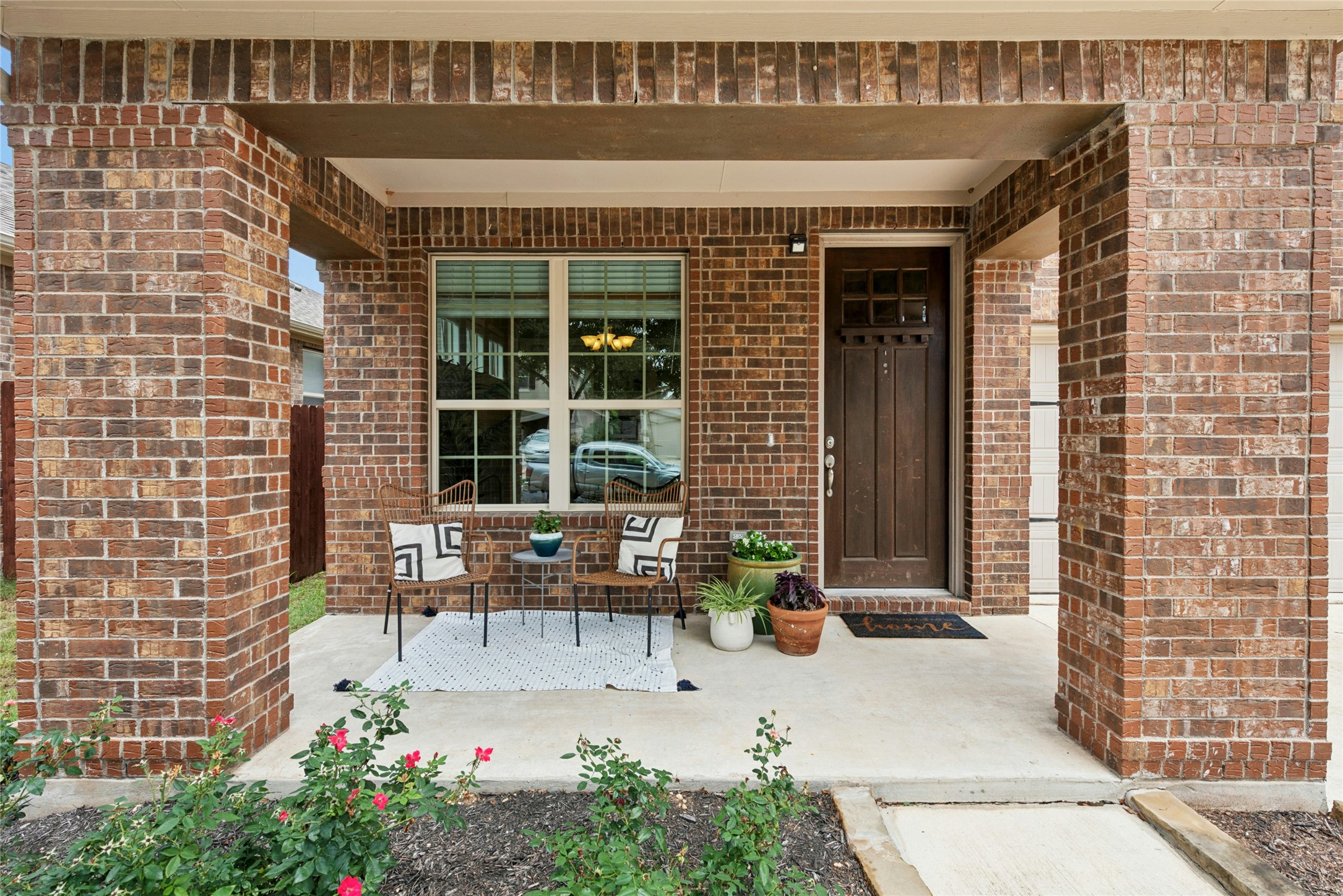390 Fletcher Bend Buda, TX 78610 - Photo 34 of 36 a front view of a house with outdoor seating