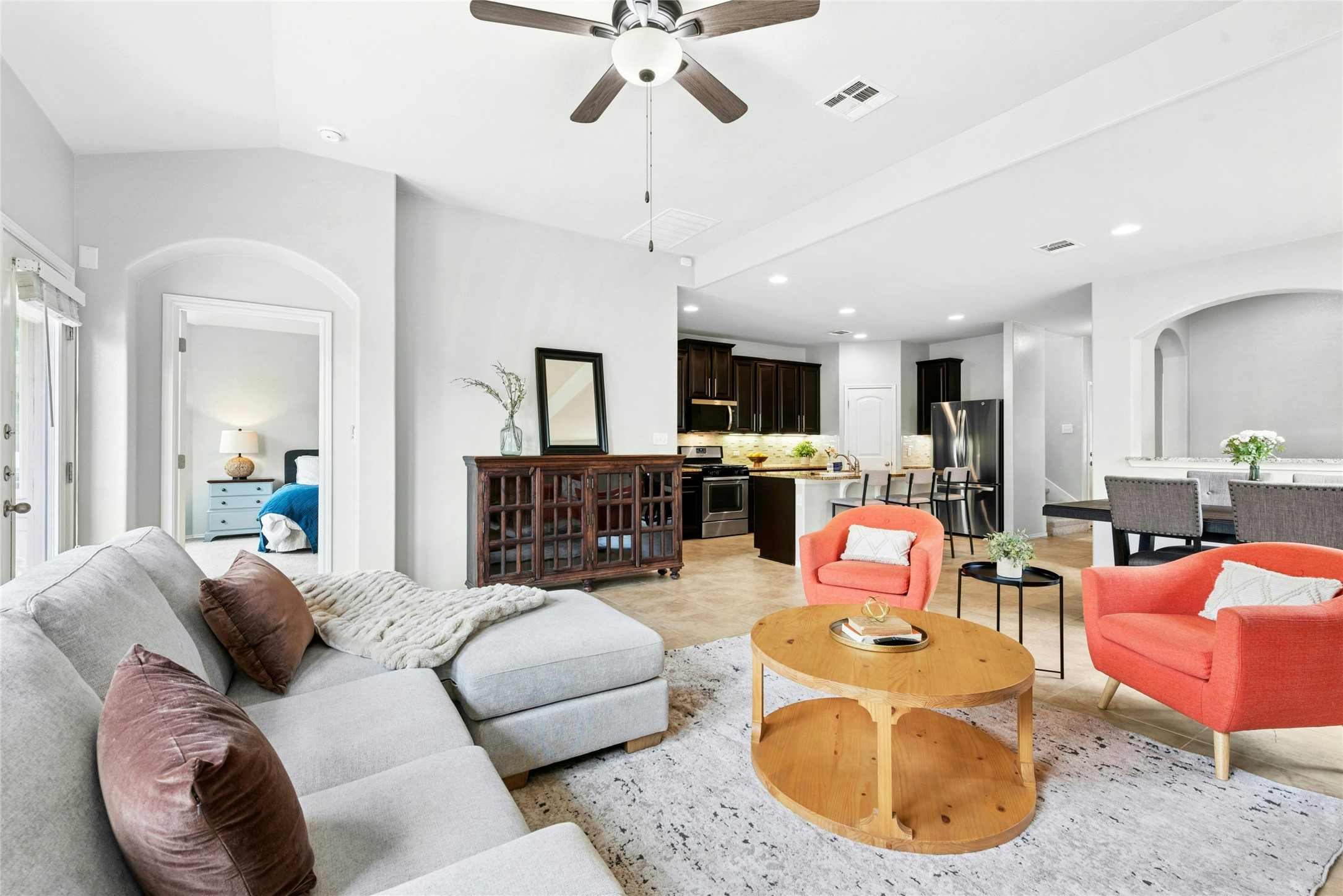 390 Fletcher Bend Buda, TX 78610 - Photo 10 of 36 a living room with furniture kitchen view and a chandelier