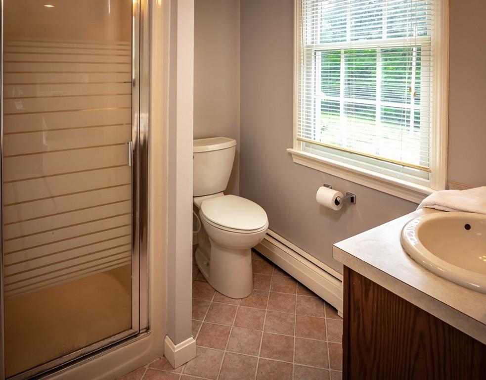 112 Upton Road Westborough, MA 01581 - Photo 24 of 41 a bathroom with a toilet sink and mirror