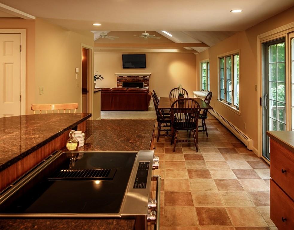 112 Upton Road Westborough, MA 01581 - Photo 9 of 41 a living room with a table and a flat screen tv