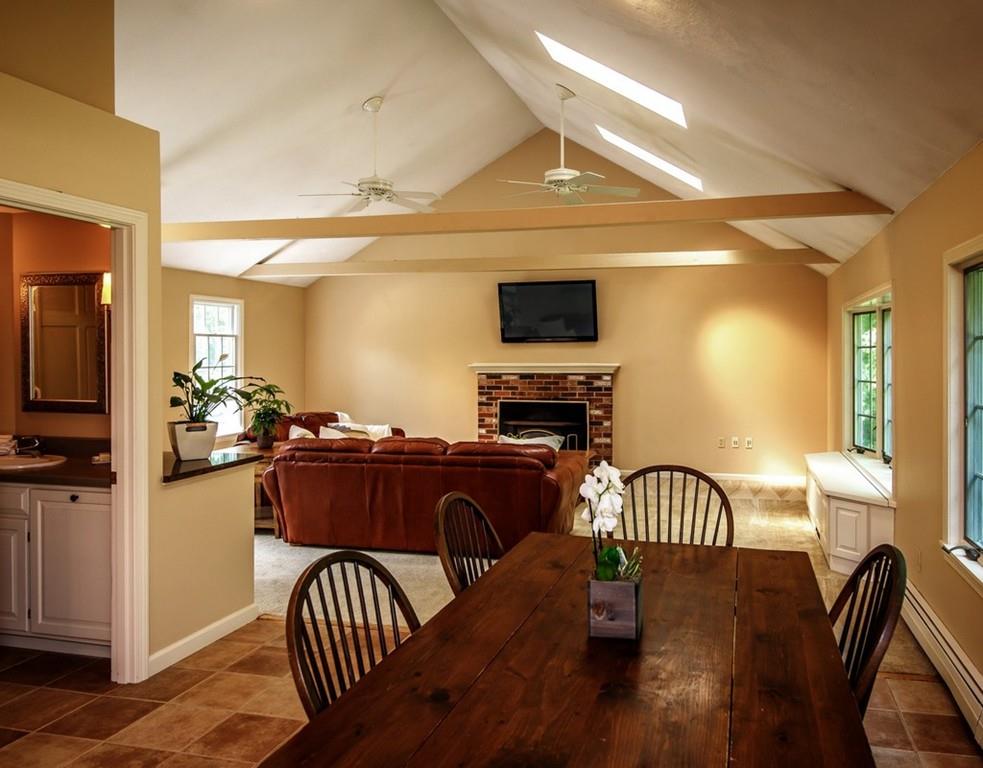112 Upton Road Westborough, MA 01581 - Photo 10 of 41 a view of a livingroom with furniture a flat screen tv and wooden floor