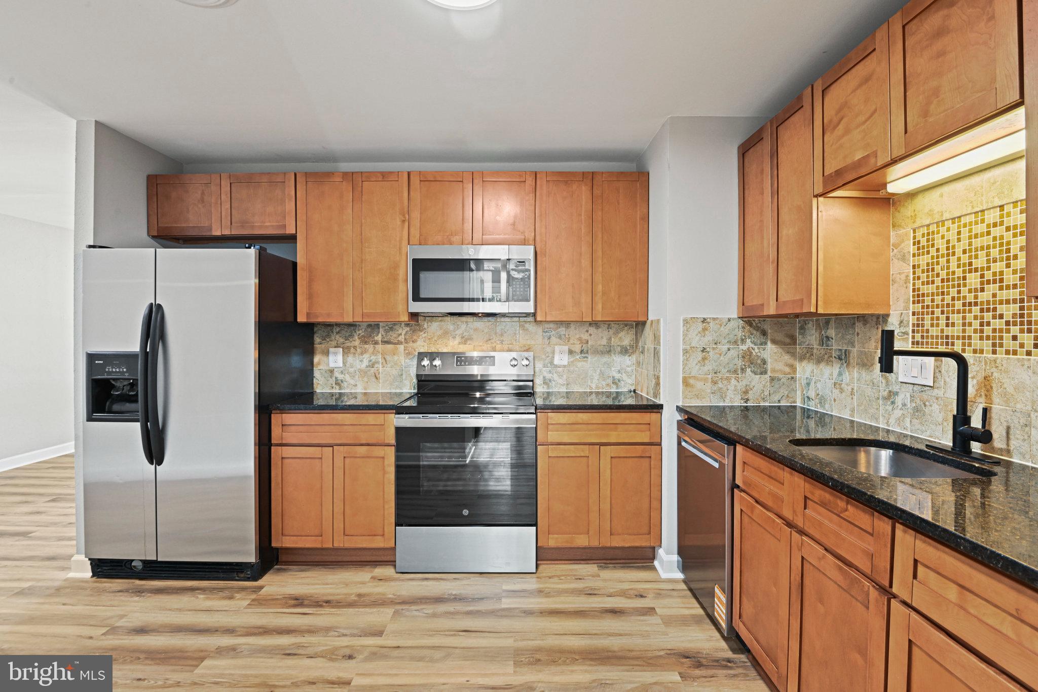 1002 South Buckingham Road Sterling, VA 20164 - Photo 6 of 18 a kitchen with stainless steel appliances granite countertop a refrigerator sink and stove