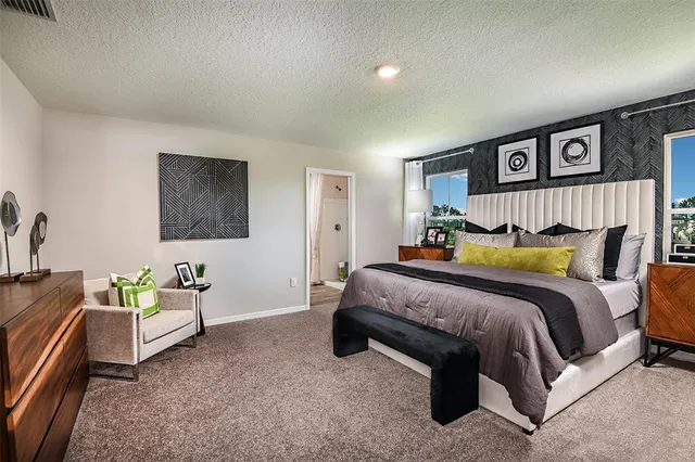 a spacious bedroom with a bed and a couch