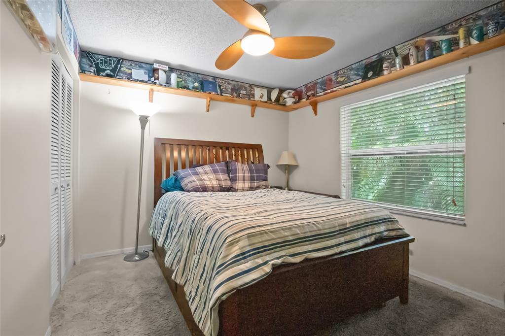 12626 Southwest 9th Place Davie, FL 33325 - Photo 13 of 26 a bedroom with a bed and a chandelier