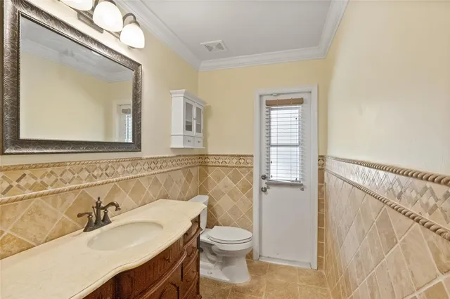 a bathroom with a granite countertop sink toilet a large mirror and shower