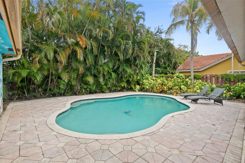 12626 Southwest 9th Place Davie, FL 33325 - Photo 19 of 26 a view of a swimming pool with a yard