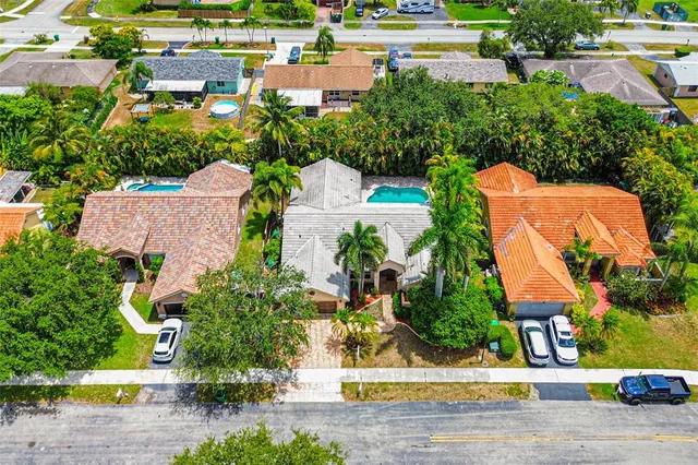 an aerial view of a house with a yard and lake view