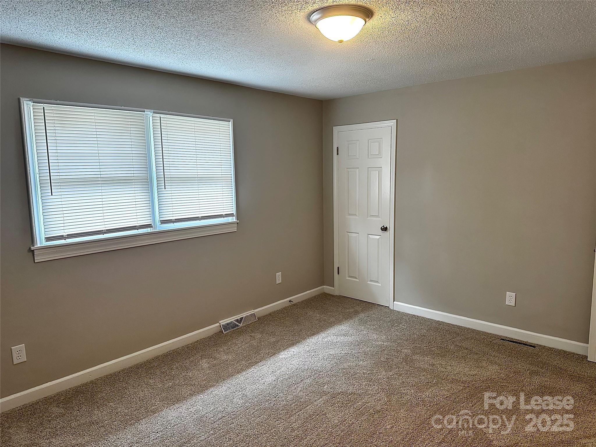 916 West 5th Avenue, Unit C Lexington, NC 27292 - Photo 16 of 24 an empty room with windows