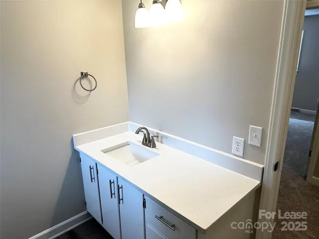 a bathroom with a sink vanity and a mirror