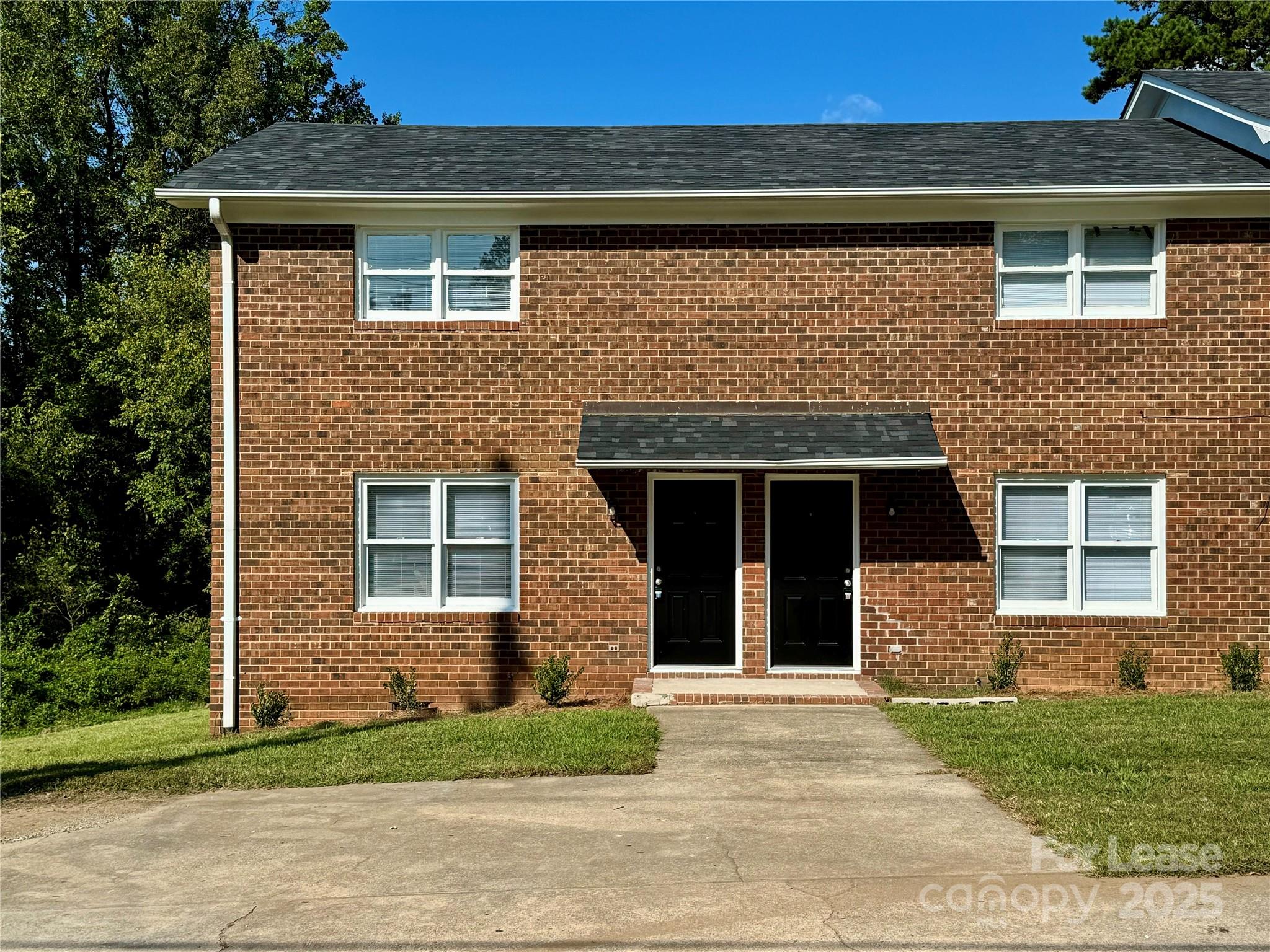 916 West 5th Avenue, Unit C Lexington, NC 27292 - Photo 2 of 24 a front view of a house with a yard and garage