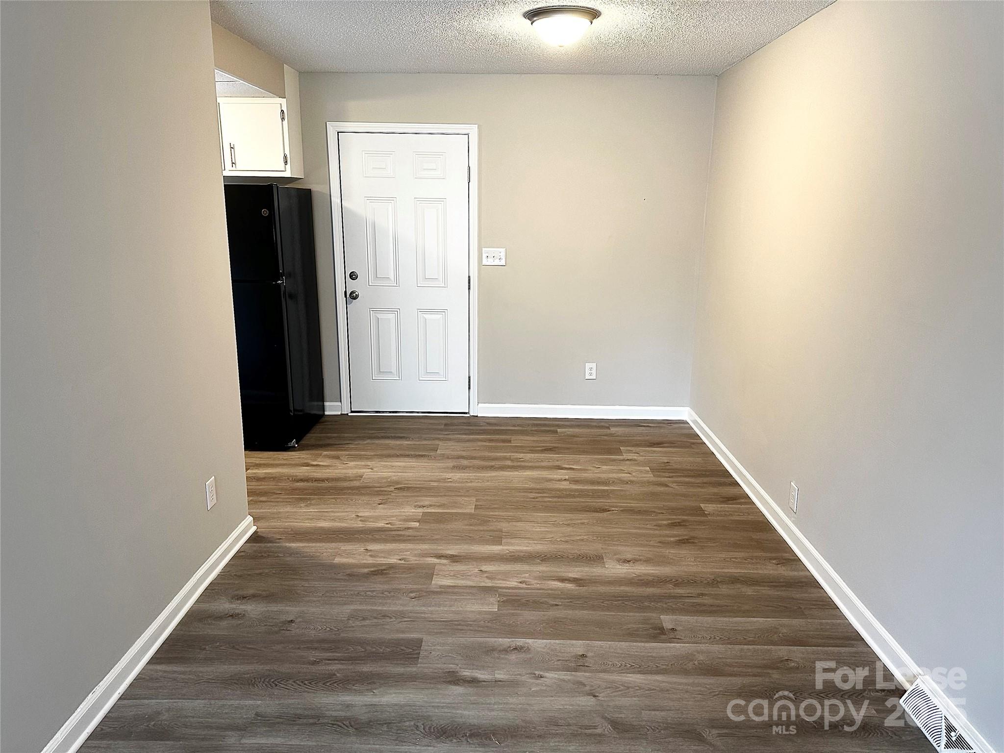 916 West 5th Avenue, Unit C Lexington, NC 27292 - Photo 8 of 24 a view of an empty room with wooden floor