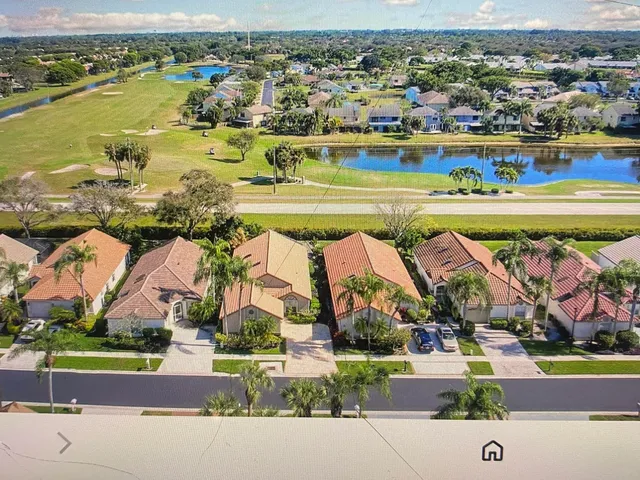 an aerial view of beach and residential houses with outdoor space