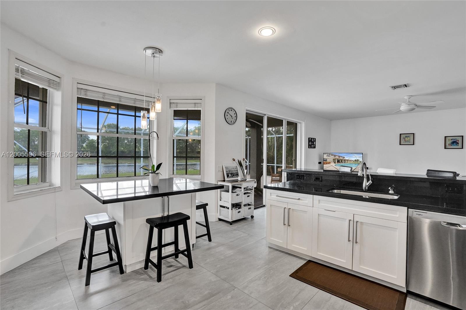 4281 Laurel Ridge Circle Weston, FL 33331 - Photo 32 of 80 a kitchen with granite countertop a sink and white cabinets