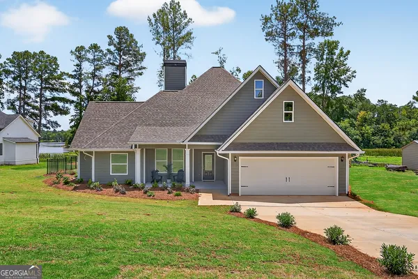 a front view of house with yard and green space