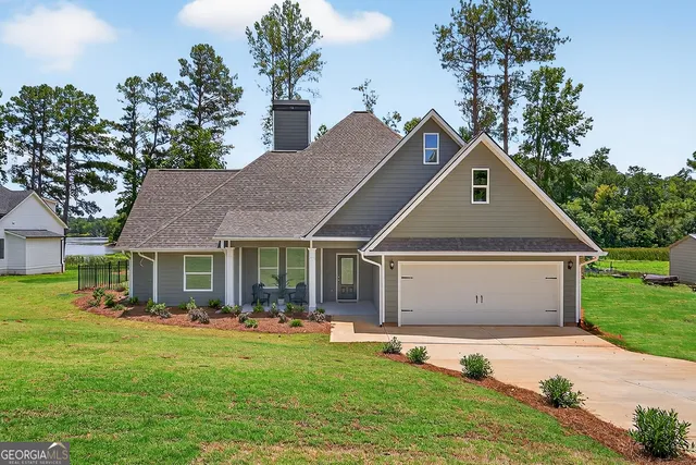 a front view of house with yard and green space