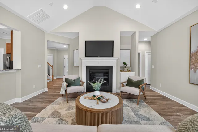 a view of kitchen with stainless steel appliances refrigerator stove microwave and cabinets