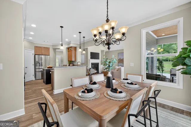 a view of kitchen with stainless steel appliances granite countertop cabinets and wooden floor
