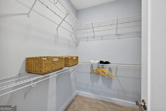 a spacious bathroom with a double vanity sink a mirror and a bathtub