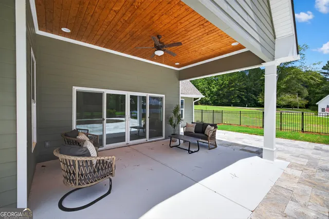 a view of a patio with a table chairs and a backyard