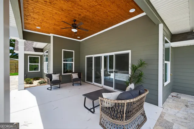 a view of a patio with chair table and chairs