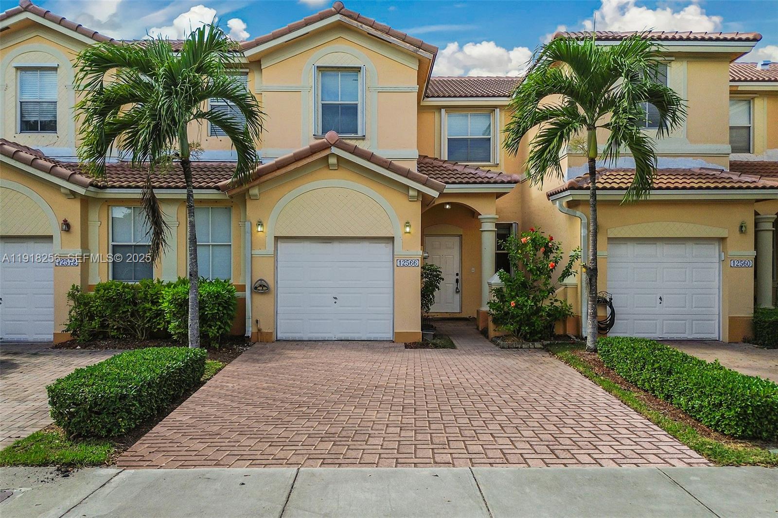 12566 Southwest 126th Avenue Miami, FL 33186 - Photo 11 of 59 a front view of a house with a yard