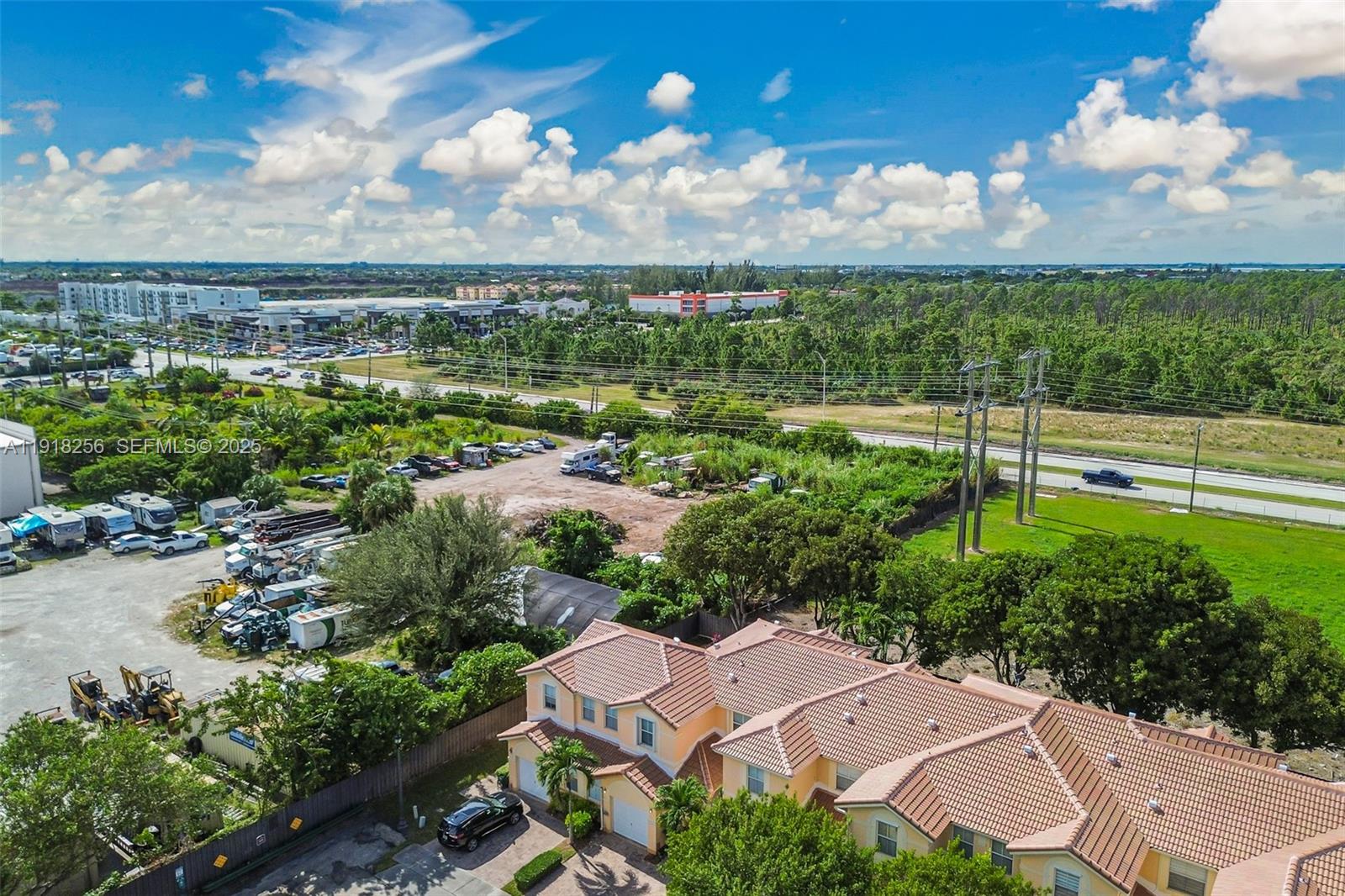 12566 Southwest 126th Avenue Miami, FL 33186 - Photo 18 of 59 an aerial view of a city with lots of residential buildings ocean and mountain view in back