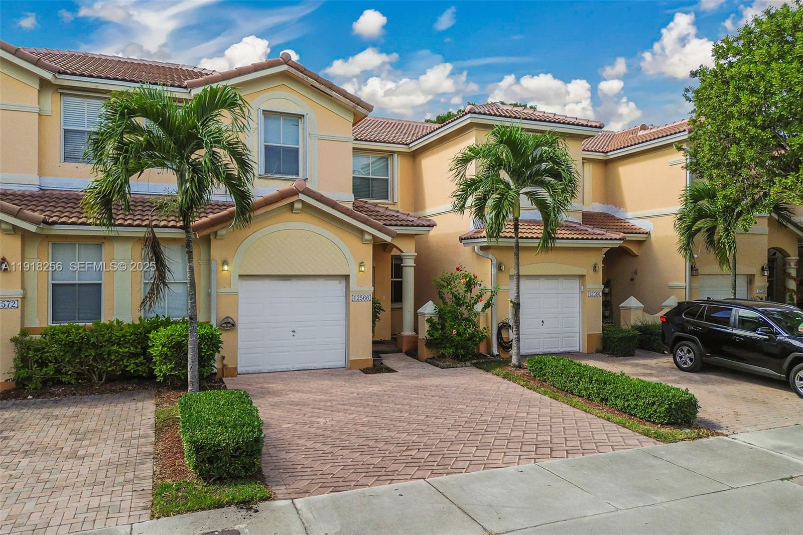 12566 Southwest 126th Avenue Miami, FL 33186 - Photo 2 of 59 a front view of a house with garden