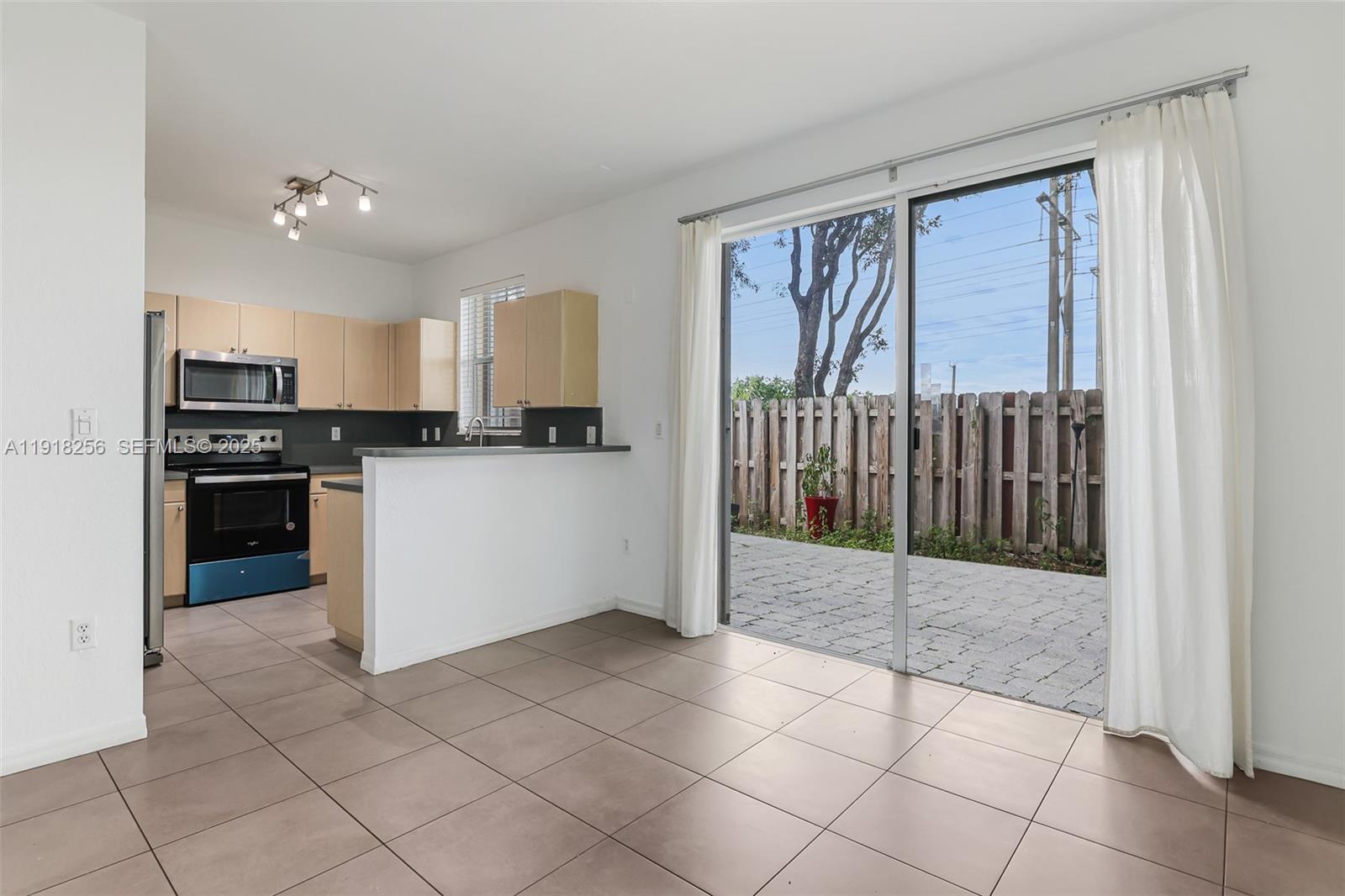 12566 Southwest 126th Avenue Miami, FL 33186 - Photo 26 of 59 a kitchen with granite countertop a refrigerator and a stove top oven