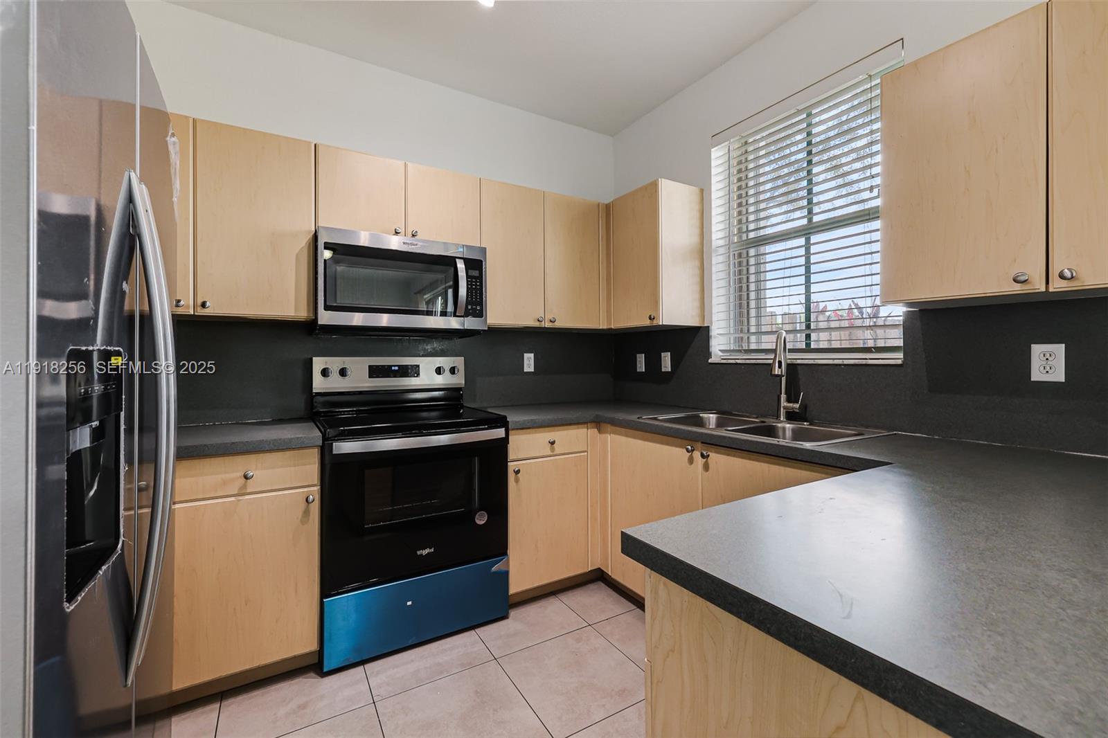 12566 Southwest 126th Avenue Miami, FL 33186 - Photo 30 of 59 a kitchen with stainless steel appliances granite countertop a stove a sink and a microwave