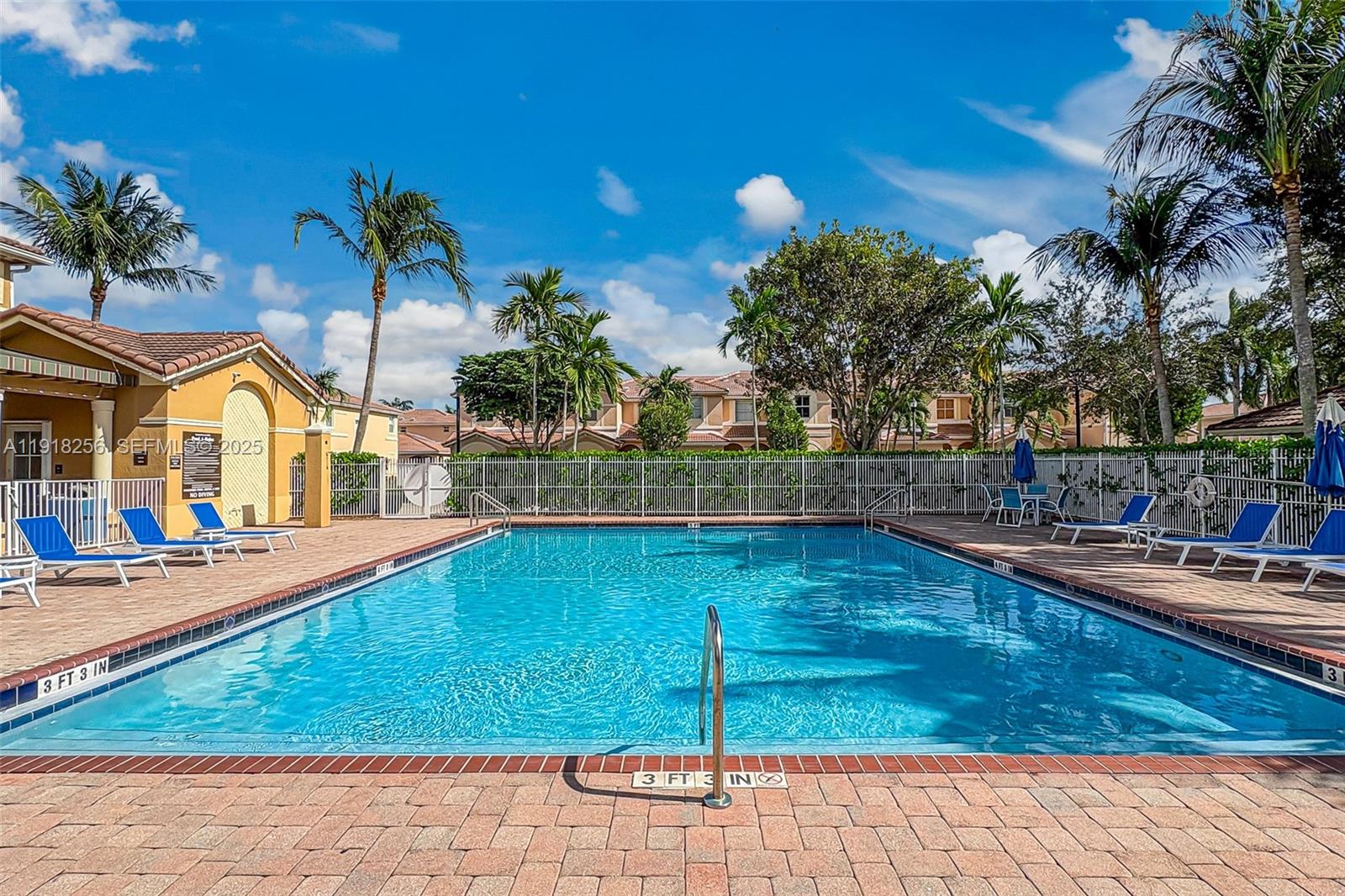 12566 Southwest 126th Avenue Miami, FL 33186 - Photo 3 of 59 a view of a swimming pool with lounge chair