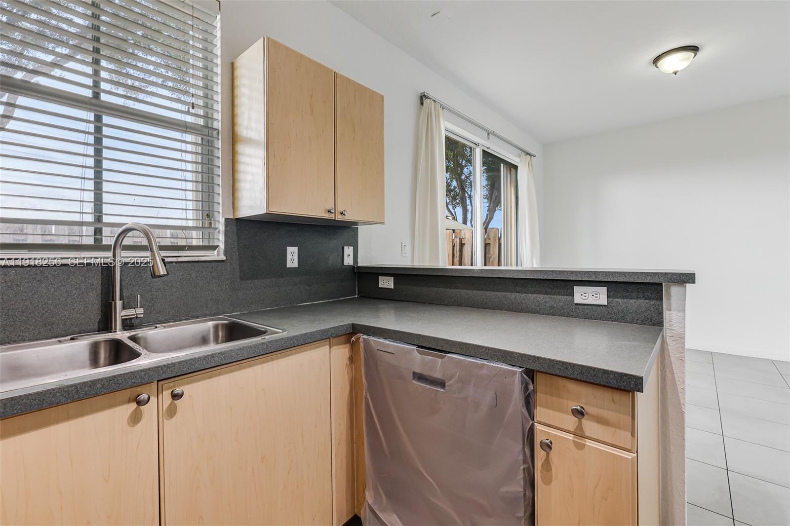 12566 Southwest 126th Avenue Miami, FL 33186 - Photo 31 of 59 a kitchen with a sink cabinets and window