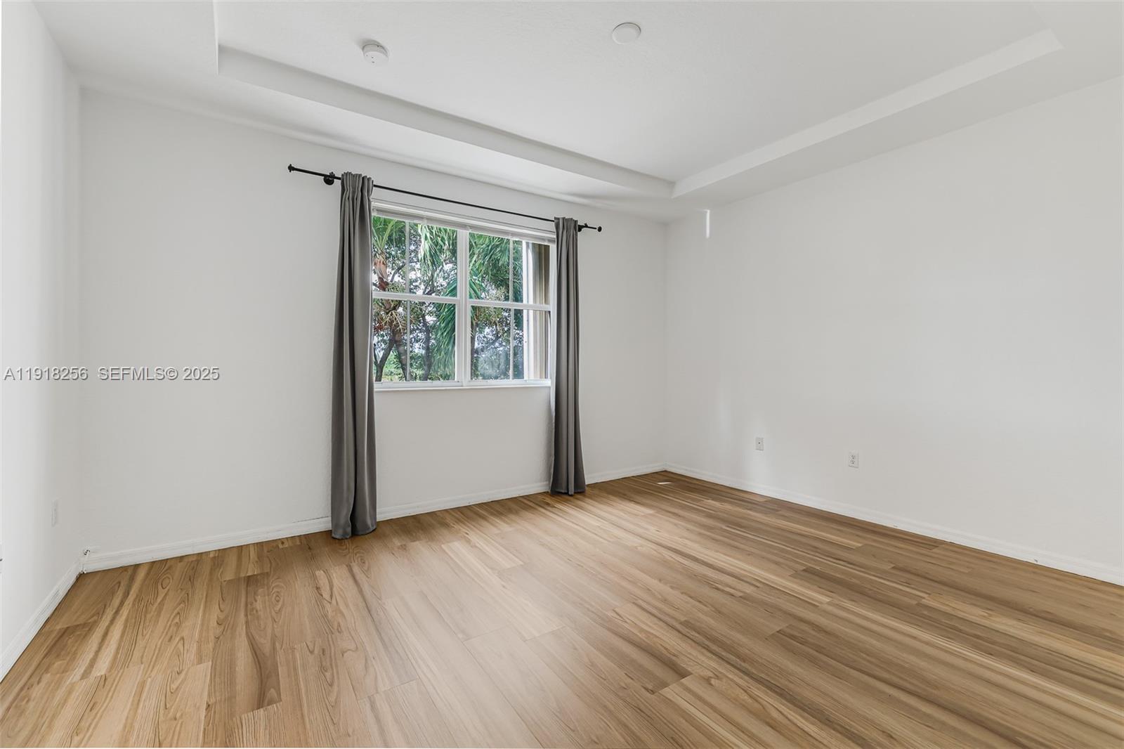 12566 Southwest 126th Avenue Miami, FL 33186 - Photo 33 of 59 an empty room with wooden floor and windows