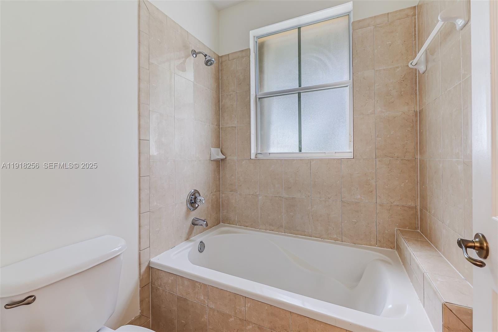 12566 Southwest 126th Avenue Miami, FL 33186 - Photo 37 of 59 a bath tub sitting next to a white sink and vanity