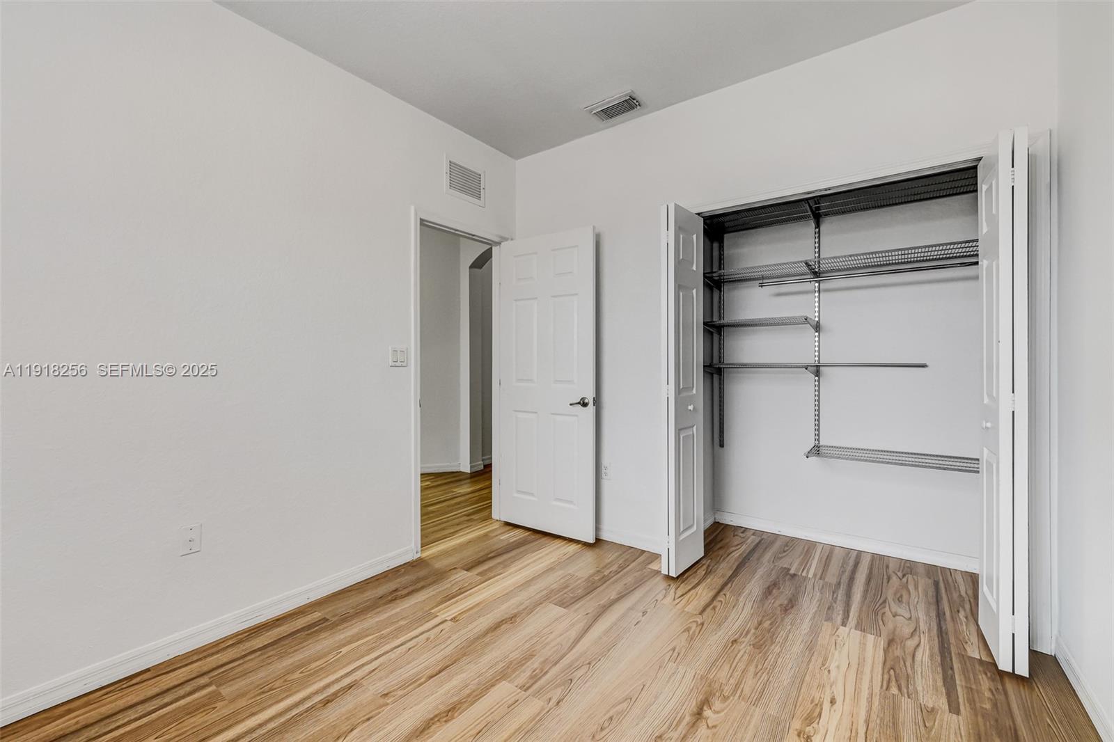 12566 Southwest 126th Avenue Miami, FL 33186 - Photo 41 of 59 a view of walk in closet with wooden floor