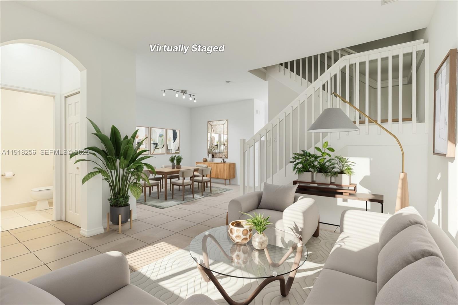 12566 Southwest 126th Avenue Miami, FL 33186 - Photo 5 of 59 a living room with furniture flowers and a dining table