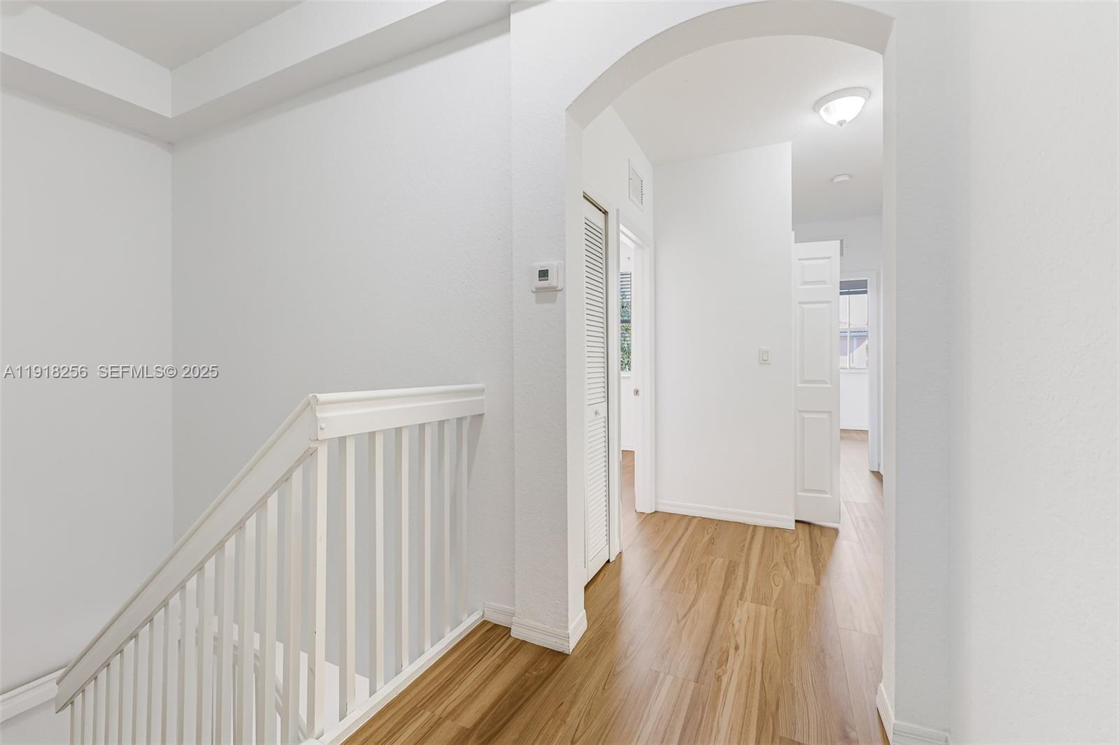 12566 Southwest 126th Avenue Miami, FL 33186 - Photo 7 of 59 a view of a hallway with wooden floor and staircase