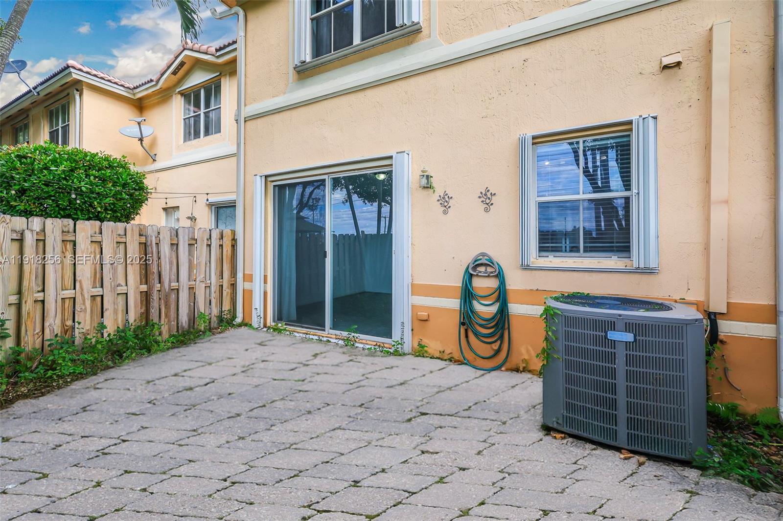 12566 Southwest 126th Avenue Miami, FL 33186 - Photo 8 of 59 a backyard of a house with barbeque oven and wooden fence