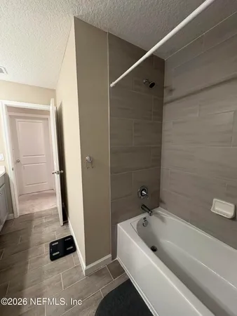 a bathroom with a tub and a shower