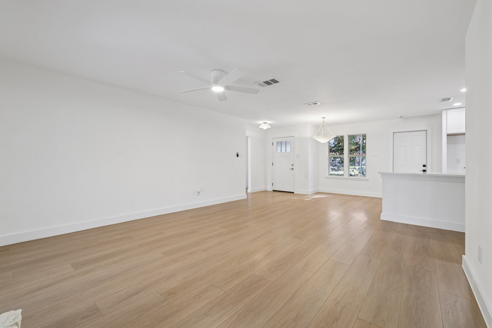 8214 Kearsarge Drive Austin, TX 78745 - Photo 15 of 40 Unfurnished living room with light wood-style floors and a ceiling fan