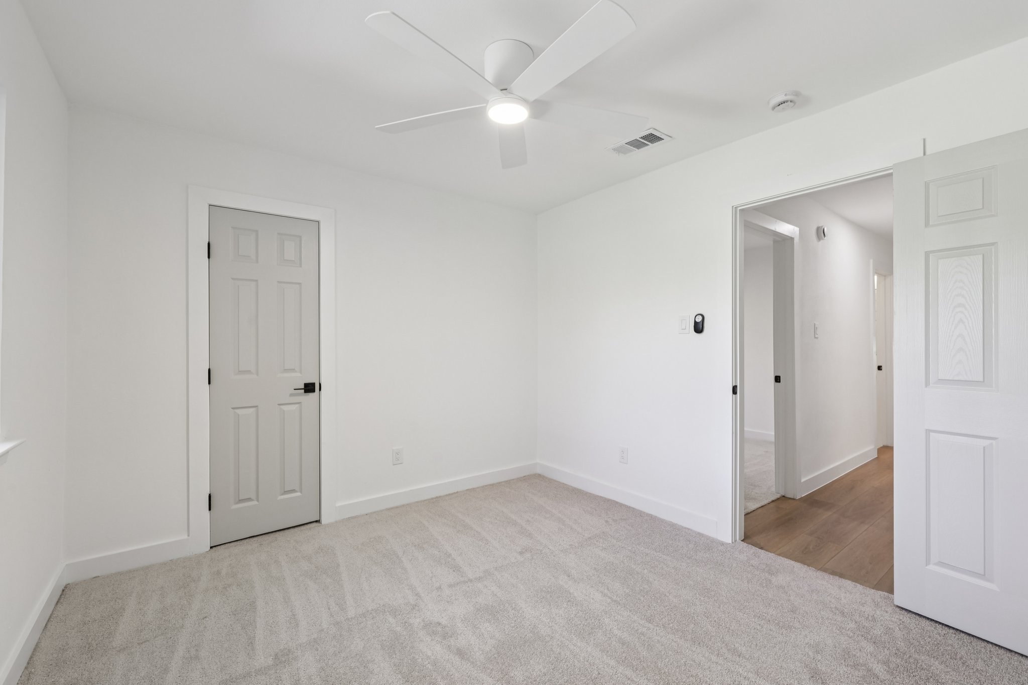 8214 Kearsarge Drive Austin, TX 78745 - Photo 25 of 40 Unfurnished room featuring light carpet and a ceiling fan