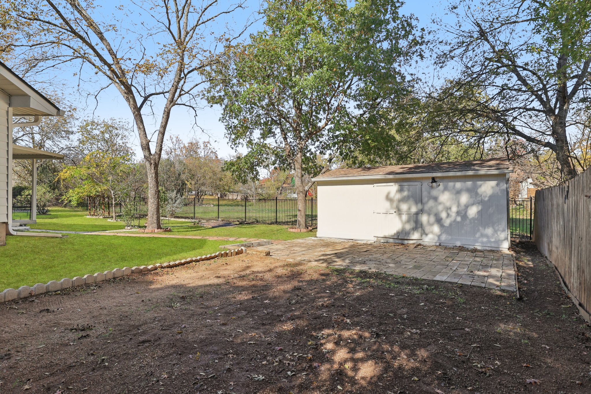 8214 Kearsarge Drive Austin, TX 78745 - Photo 36 of 40 Fenced backyard featuring an outbuilding and a patio