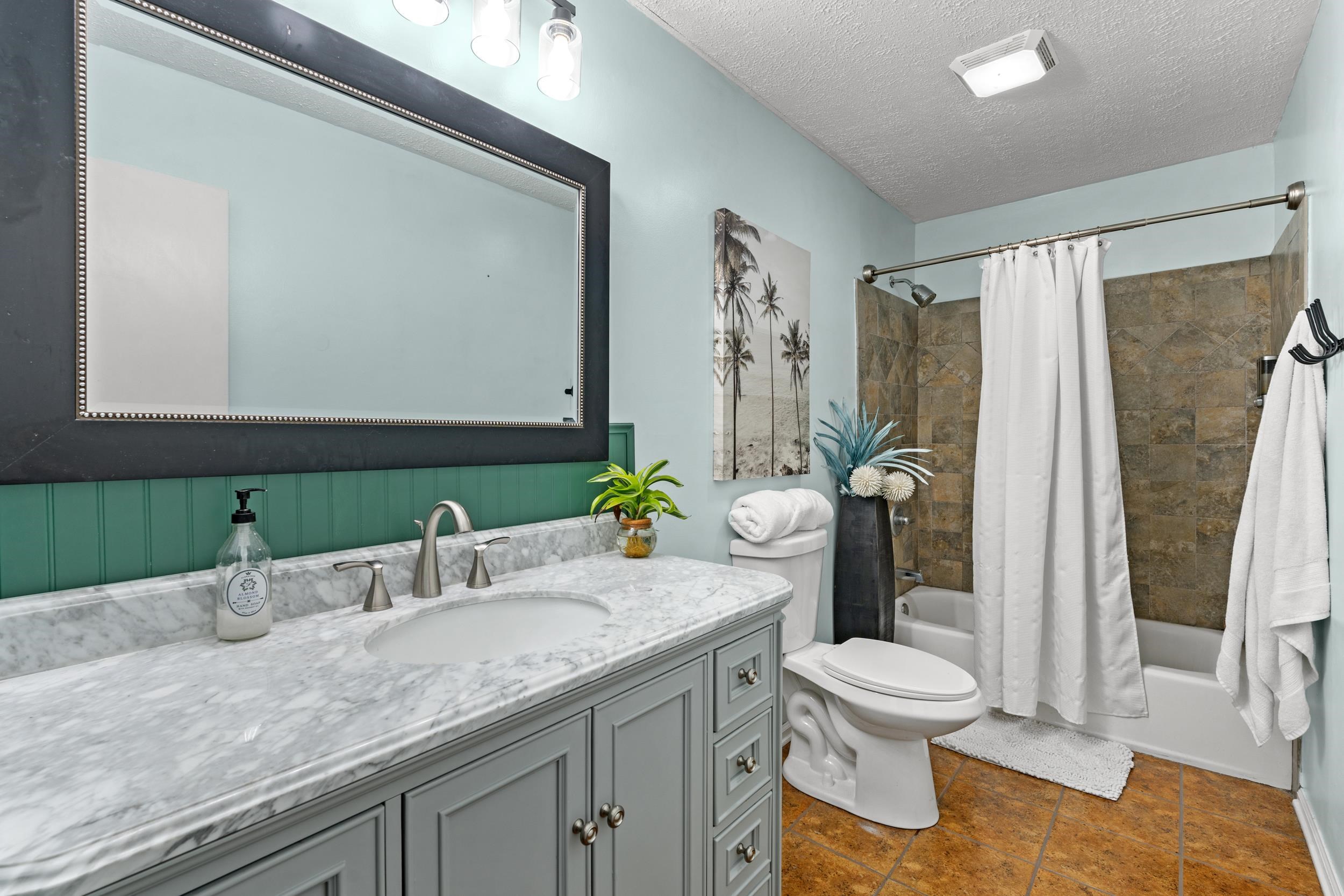 208 Bethea Street Latta, SC 29565 - Photo 15 of 36 Bathroom featuring shower / bath combination with curtain, vanity, and a textured ceiling