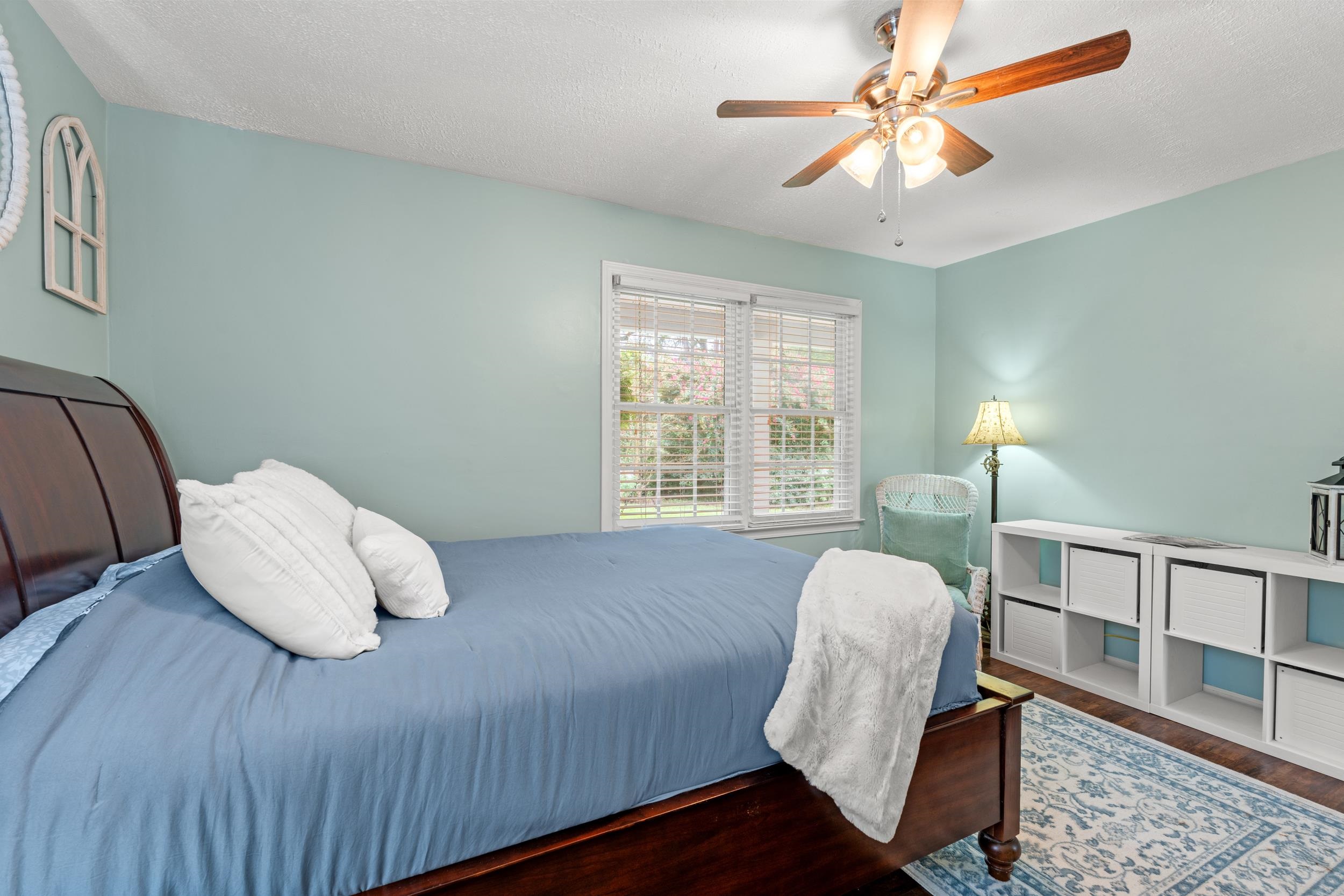 208 Bethea Street Latta, SC 29565 - Photo 19 of 36 Bedroom featuring a textured ceiling, ceiling fan, and wood finished floors