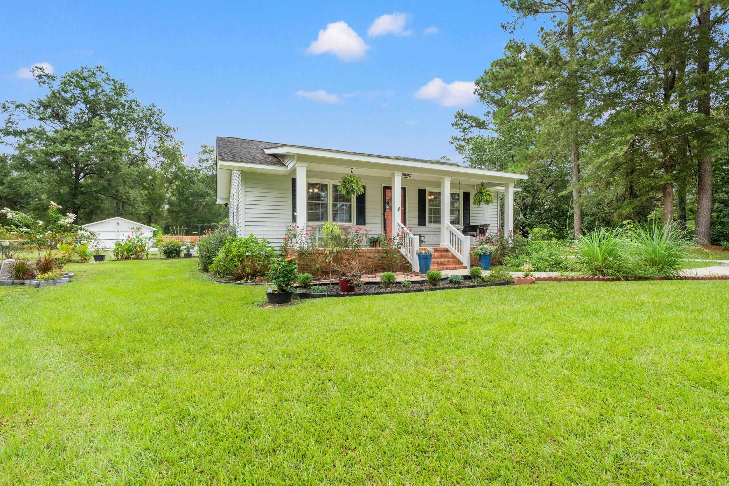 208 Bethea Street Latta, SC 29565 - Photo 31 of 36 Bungalow-style home featuring covered porch and a front lawn