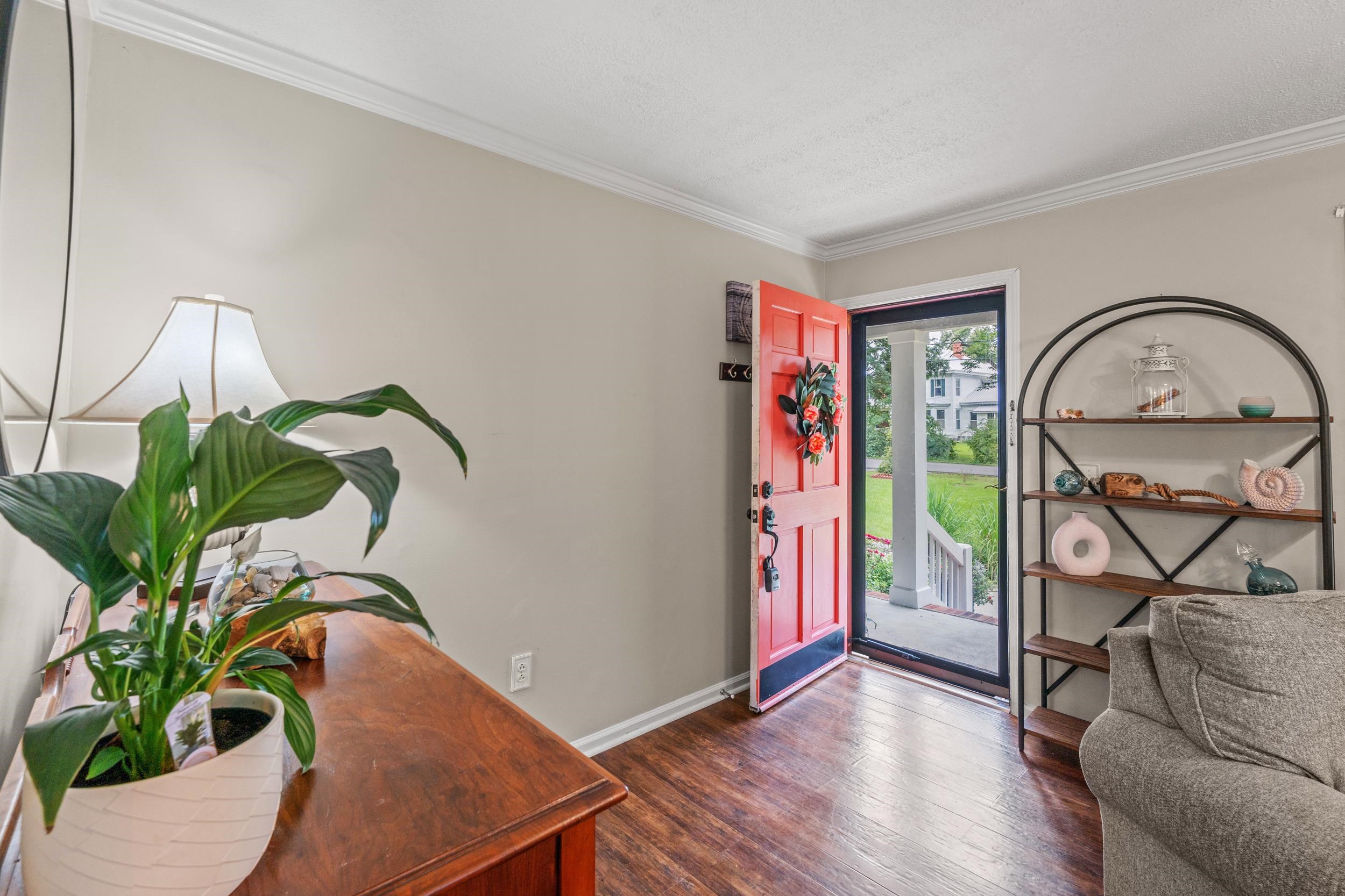 208 Bethea Street Latta, SC 29565 - Photo 5 of 36 Foyer entrance with crown molding and wood finished floors