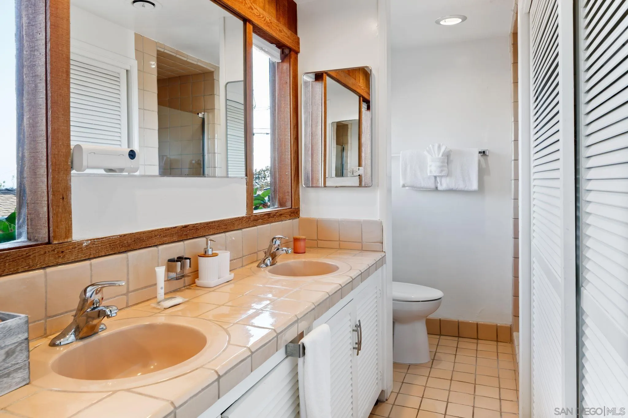 5643 Linda Rosa Avenue La Jolla, CA 92037 - Photo 19 of 56 a bathroom with a sink and a mirror