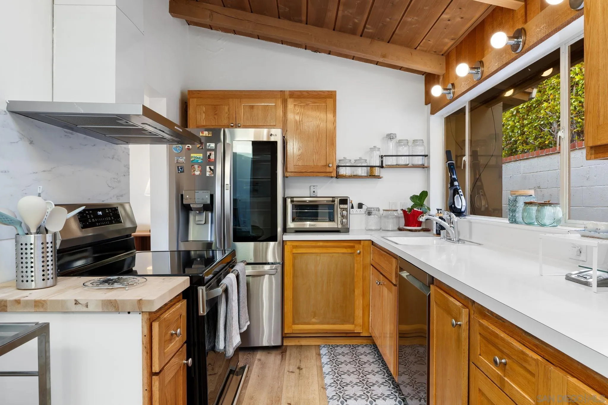 5643 Linda Rosa Avenue La Jolla, CA 92037 - Photo 22 of 56 a kitchen that has a sink and a stove top oven